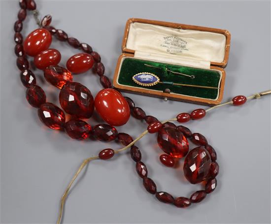 Simulated cherry amber including loose beads, necklace etc and two stick pins.